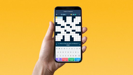 A hand holding up a mobile with a word game on it