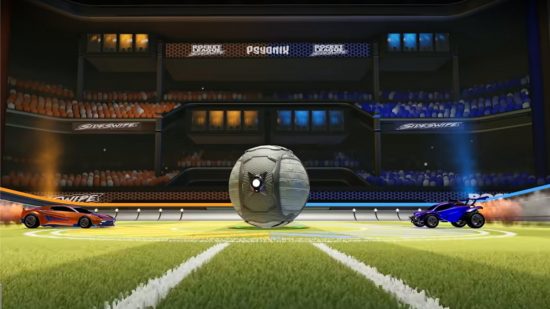 An orange car and a blue car on opposite sides of the field with a ball in the middle