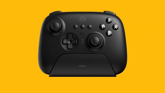 Switch contrtollers: a black 8BitDo Ultimate controller is visible against a yellow background