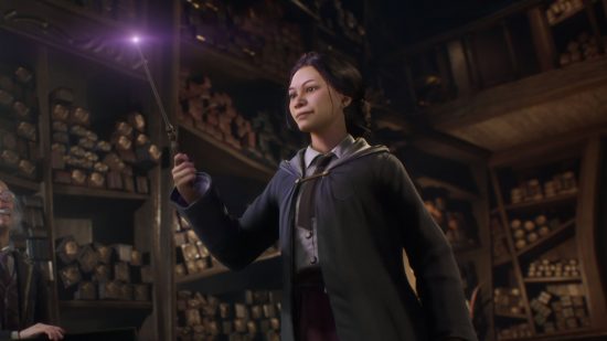 Hogwarts Legacy pre-orders - a screenshot from Hogwarts Legacy showing a woman in a gown, shirt and tie stood in an old library next to an old man holding her wand in the air with its tip glowing.