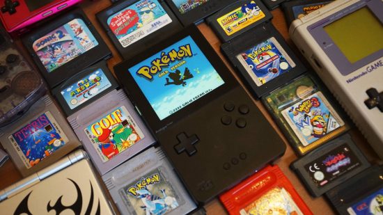 Analogue Pocket review: An Analogue Pocket is shown beside a pile of Game Boy games