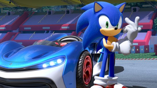 Best Sonic games: A screenshot from the Team Sonic Racing website showing Sonic standing next to a blue racecar in an arena.