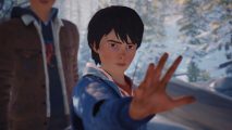 Life is Strange 2 Switch release: A screenshot of Daniel Diaz, a young brown-haired Latino boy wearing a blue hoodie, holding out his hand with a concentrated look on his face.