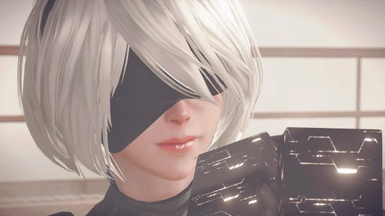 Nier Automata 2B: A close up screenshot of 2B from Nier Automata. She has a while bob haircut with a side fringe, and a black blindfold covers her eyes..