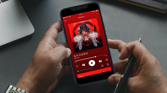 What is Spotify: A photo of a pair of hands holding a smartphone. The phone is showing the Spotify music player screen playing King by Kanaria.