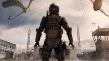 Call of Duty Warzone Mobile for iOS: A soldier standing with their back to the camera in an open area flanked by buildings with a parachute dropping from above.