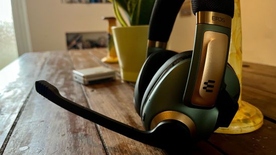 Epos H3Pro review - a pair of over-ear headphones with a microphone extended on a wooden table.