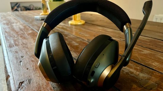 Epos H3Pro review - a pair of over-ear headphones with a microphone extended sat on a wooden table.