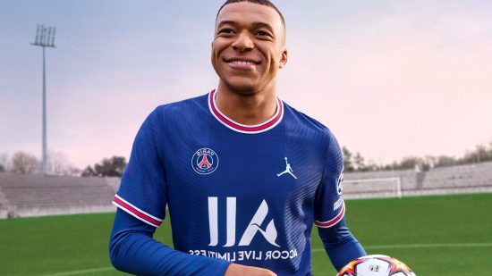 FIFA 23 career mode - Kylian Mbappe, holding a football, looking happy, ona green football pitch with bright sky behind him.He has short shaved hair and a PSG kit on.