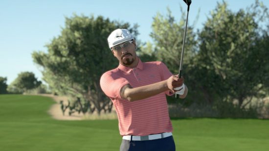 Golf games: A male golfer with a goatie beard wearing a white cap, a pink striped polo shirt, and black shorts with a white belt is mid-swing on a golf course in PGA Tour 2K21.