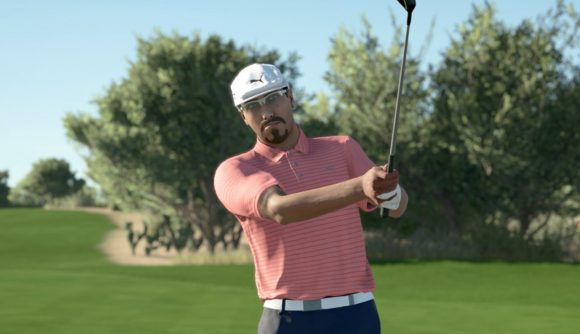 Golf games: A male golfer with a goatie beard wearing a white cap, a pink striped polo shirt, and black shorts with a white belt is mid-swing on a golf course in PGA Tour 2K21.
