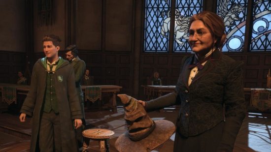 Hogwarts Legacy review - a student stood next to the sorting hat in Slytherin house