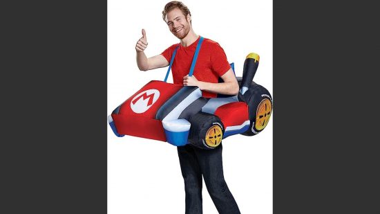 Mario and Luigi costumes; a man in a red tshirt and black trousers doing a thumbs up, with a mario kart over his shoulders and around his waist.