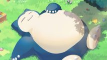 Pokemon Sleep release date: Snorlax in Pokemon Sleep asleep in a green meadow, with one hand on its belly.