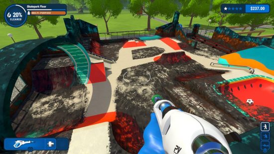PowerWash Simulator Switch review: A screenshot of a half-cleaned skate park from the POV of someone holding a pressure washer.