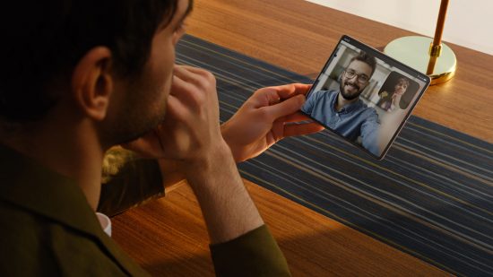 Press image of someone using a Tecno Shadow V Fold for video calling a friend