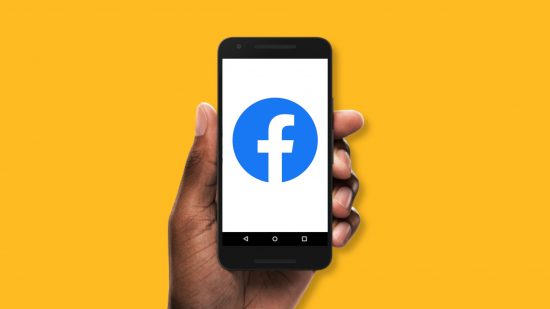What is Facebook - a hand holding a phone with the Facebook logo on the screen