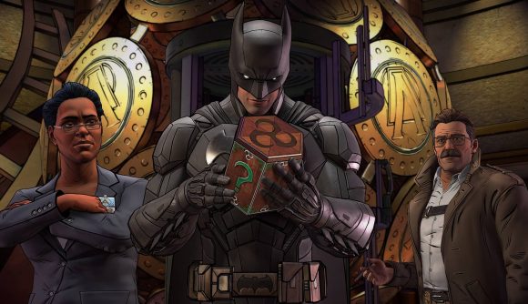 Batman games - Batman looks at a box with a question mark on it, in a building with large gold circles adorning the background, next to a woman in a suit and a man in a tie-less suit.