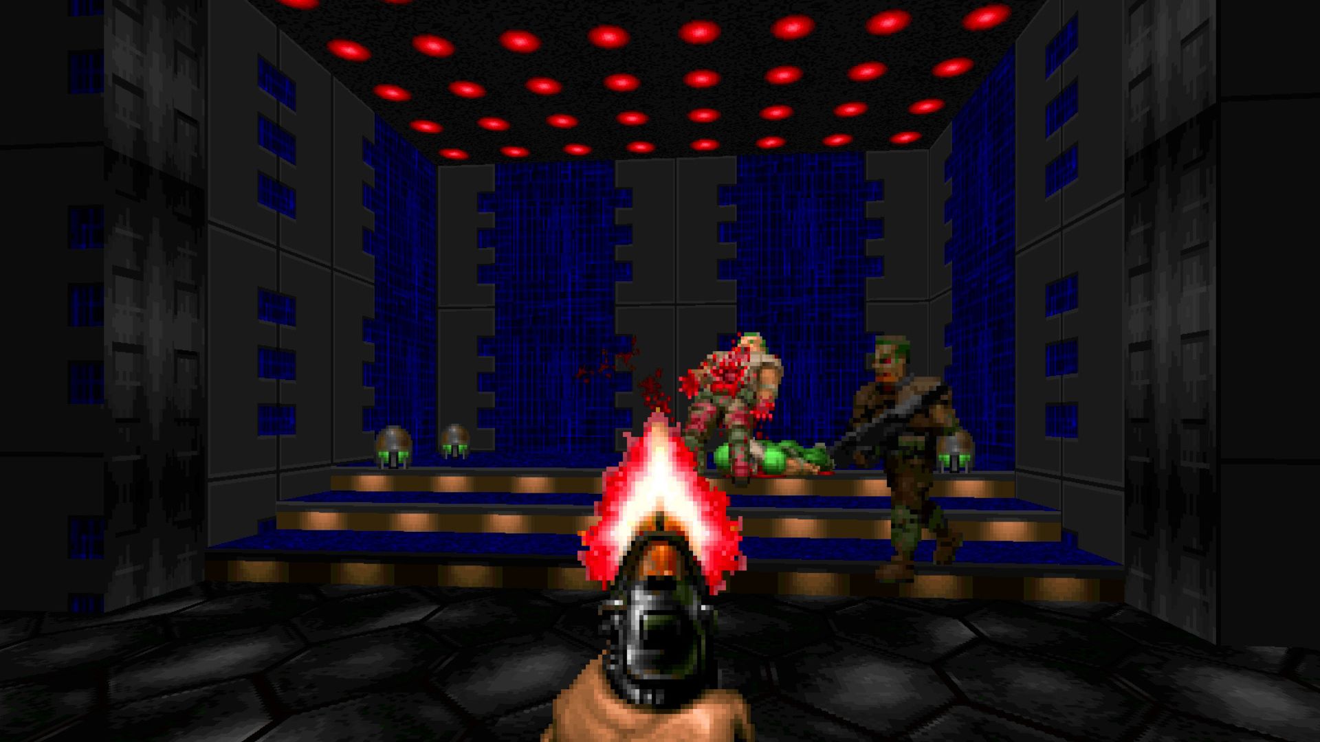 FPS games - a first person shot of a man holding a gun out in a room with red lights on the roof and pixelated demons dying in front of him.