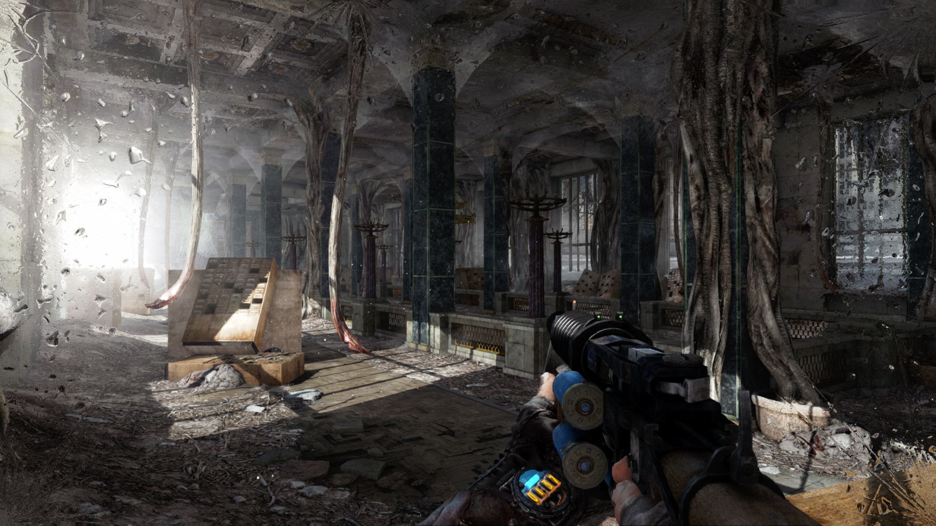 FPS games - a first person shot of a person holding a large pistol out in front of them in a warehouse with broken windows full of trash with some light bleeding in from the left.