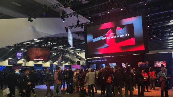 GDC 2023's AI innovations led by Unity, photo showing the company's booth at the conference, with a crowd of people milling about a large screen above.