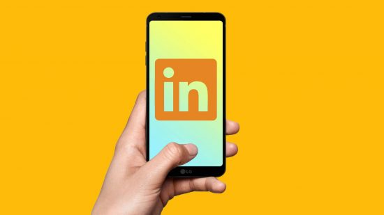 How to cancel Linkedin Premium: a hand holds a phone against a yellow background, with the linkedin premium logo on the screen