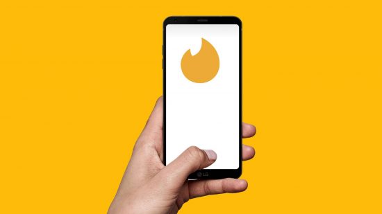 How to cancel Tinder Gold: a hand is shown holding a phone, with the Tinder Gold icon visible on the screen