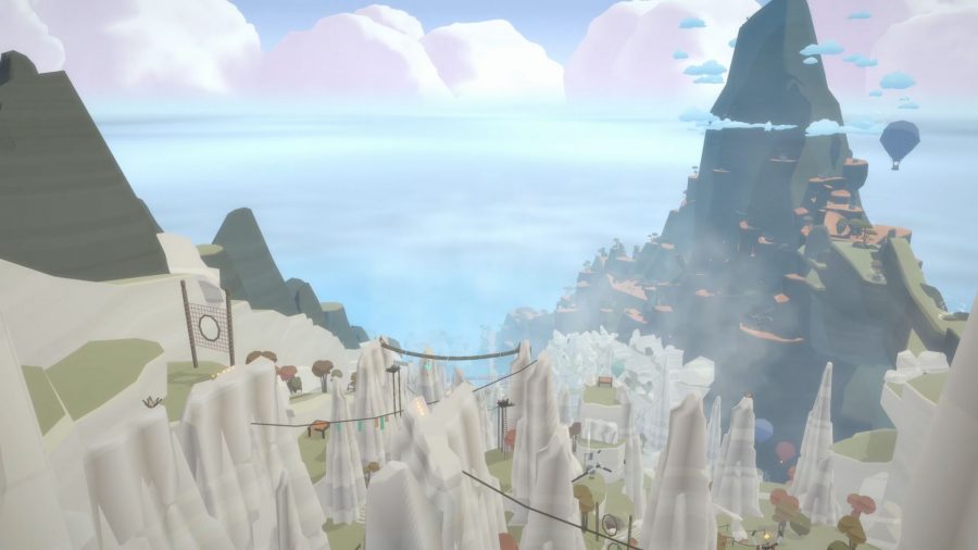 A screenshot from Laya's Horizon showing a deep valley with a large mountain at the other end, dotted with rocks, wires hanging between them, and a wide open sea in the distance.