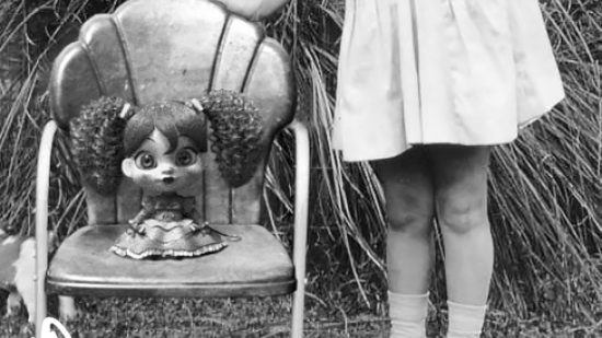 An old fashioned photo of Poppy Playtime Poppy sitting on a chair beside a young girl