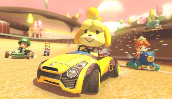 Scooter games -- a shot from MK8 showing a cartoon dog in a car driving along a sandy road with some other kart racers behind her.