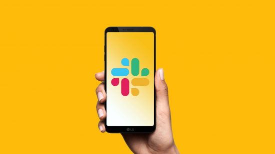 Slack download: an android device is being held in a hand, with the slack logo on the screen