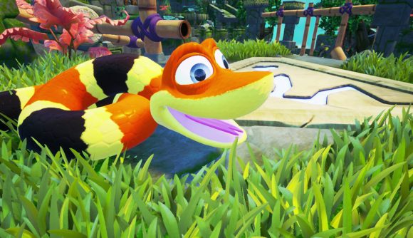 Snake games: A screenshot from Snake Pass showing a close-up of Noodle the snake in the tall grass smiling.