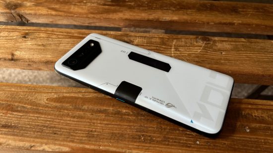 Asus ROG Phone 7 review - a white and black back of a phone, all angular, on a wooden surface.