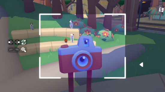 A screenshot from Pupperazzi taken in selfie mode, showing a giant red camera with legs standing in a park with dogs in the background.