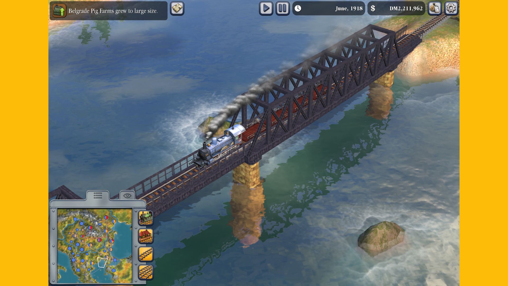 Recenzja Sid Meier's Railroads na telefony komórkowe - pociąg jadący nad wodą na dużym czarnym moście z dymem wydobywającym się z jego szczytu.