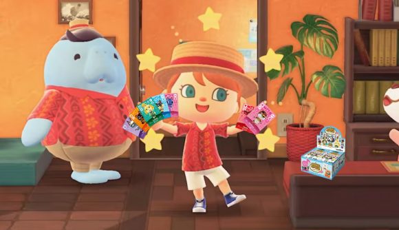 A human villager holding some different Animal Crossing Amiibo cards