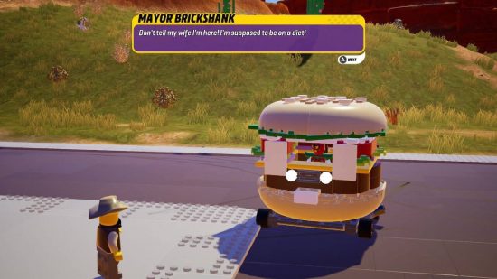 Lego 2K Drive review: a man stands next to a car made to look like a burger