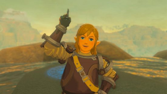 Zelda: Tears of the Kingdom six dragons - Link, a blonde boy with hair down to his shoulders, looking jovial in a bulky armor and pointing a finger in the air.