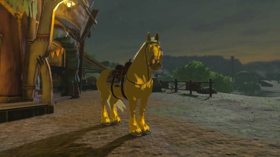 Złoty koń Zelda Tears of the Kingdom stojący przed stajnią
