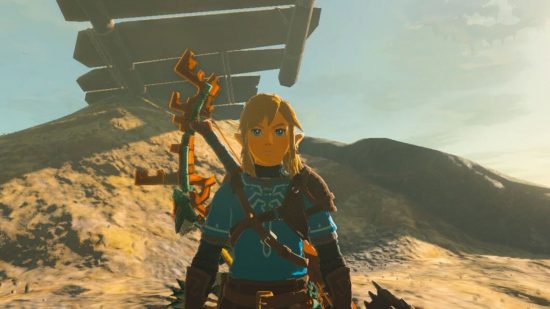 Zelda: Tears of the Kingdom armor - Link with a bow on his back standing in a desert