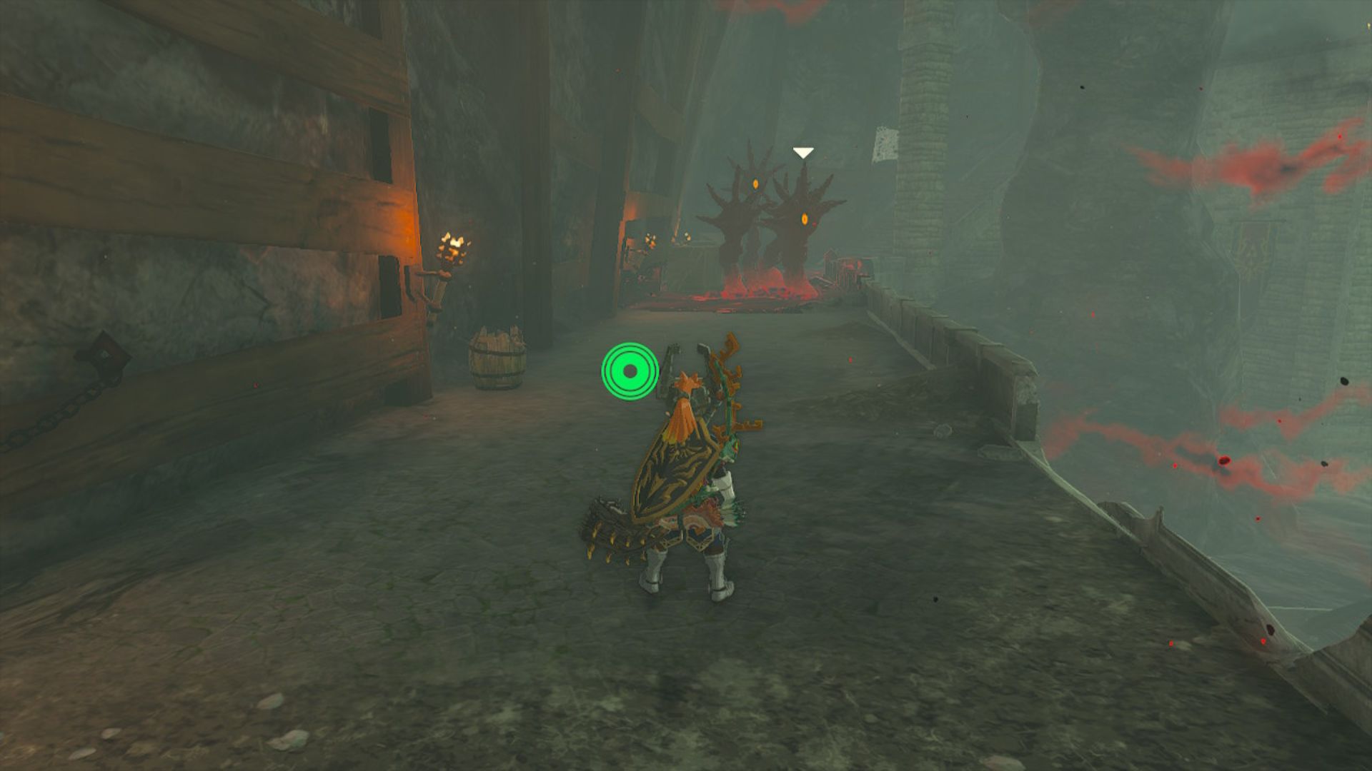 Zelda: Tears of the Kingdom Hylian shield - Link facing off against red hands sticking out the ground with eyes in their palms. They are huge arms, bigger than Link, all happening on a stone platform in a gloomy space.