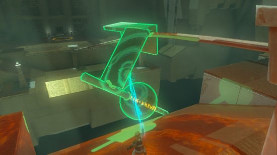 Zelda Tears of the Kingdom shrine - Link in a grey room using his force power to manipulate a rickety object of glued-together orb, sticks, and stone walls, lowering it onto a rail for it to slide along.