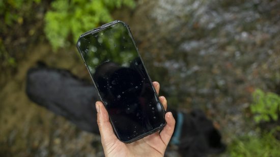 The Doogee S100 Pro torch being tested in a river