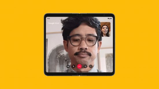 Google Pixel Fold launch pic showing the phone unfolded on a mango yellow background. It looks like a square tablet, on which someone is having a video call. A man with a moustache and glasses is in the centre of the screen, while a black-haired woman is in the top right corner in a little box.