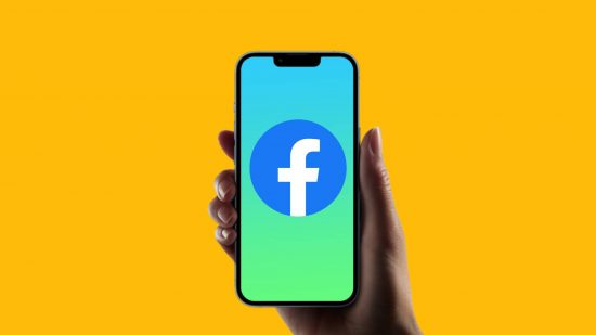 How to delete Facebook account: a hand holds a phone against a yellow background, the phone features a Facebook logo