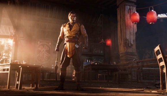 Mortal Kombat 1 crossplay - Scorpion stood in his human form in the middle of a room surrounded by tables