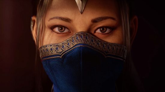 Mortal Kombat 1 release date - a woman in a blue mask with gold stitching on the top edge which covers her mouth and nose. Eyes peer out below brown eyebrows. Hair hangs loose, covering her ears, and what looks like the point of a helmet just encroaching on her forehead.