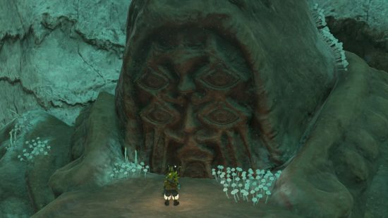 Link standing in front of a huge, stone, tears of the kingdom bargainer statue