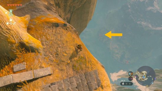 Zelda: Tears of the Kingdom autobuild: Link stands on a cliff edge with a chasm visible and a yellow arrow pointing towards it