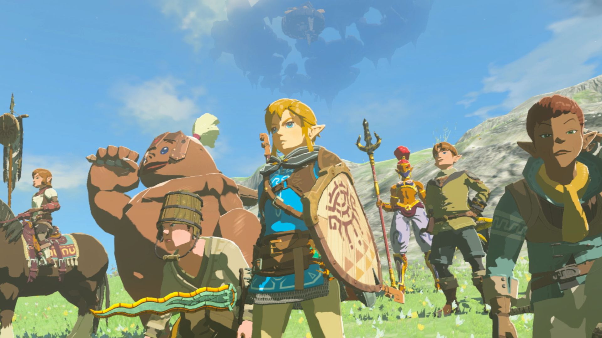 Zelda: Tears of the Kingdom review - Link, a blonde boy holding a wooden shield and glowing sword wearing a blue tunic, surrounded by friends, one tall woman in ornate armour, just a standard looking sort of medieval farmer-type, a large rock man, and some others.